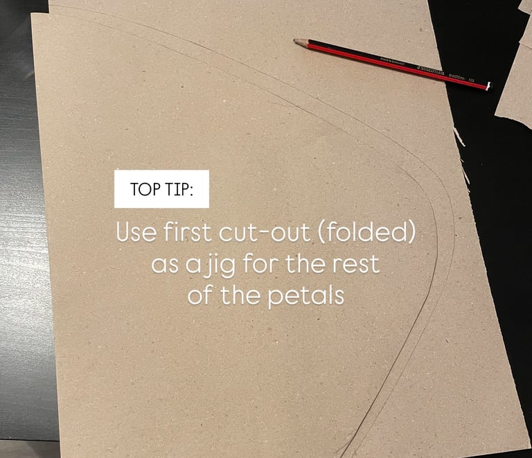 brown paper petal folded in half to use as a jig or mould