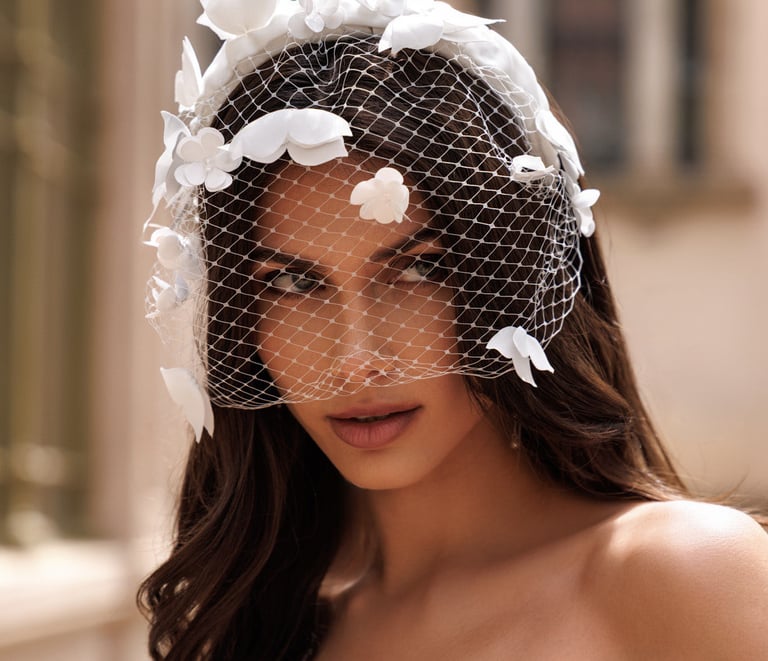 a woman in a wedding dress with a veil and veil
