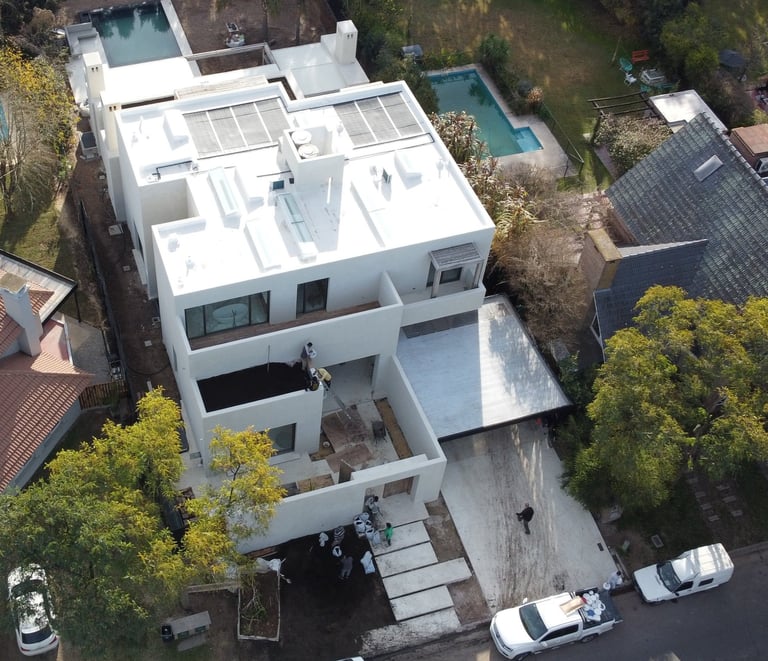a house with a pool and a pool in the background