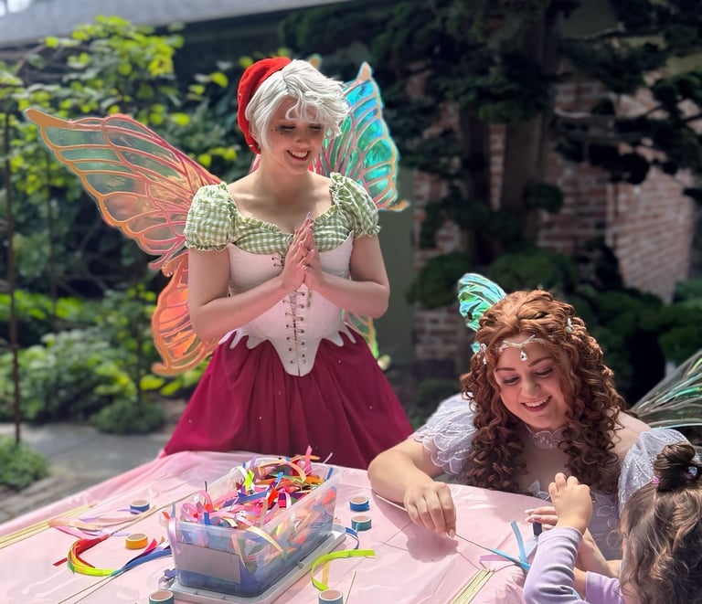 Strawberry and Purple Fairy do a craft with. a child