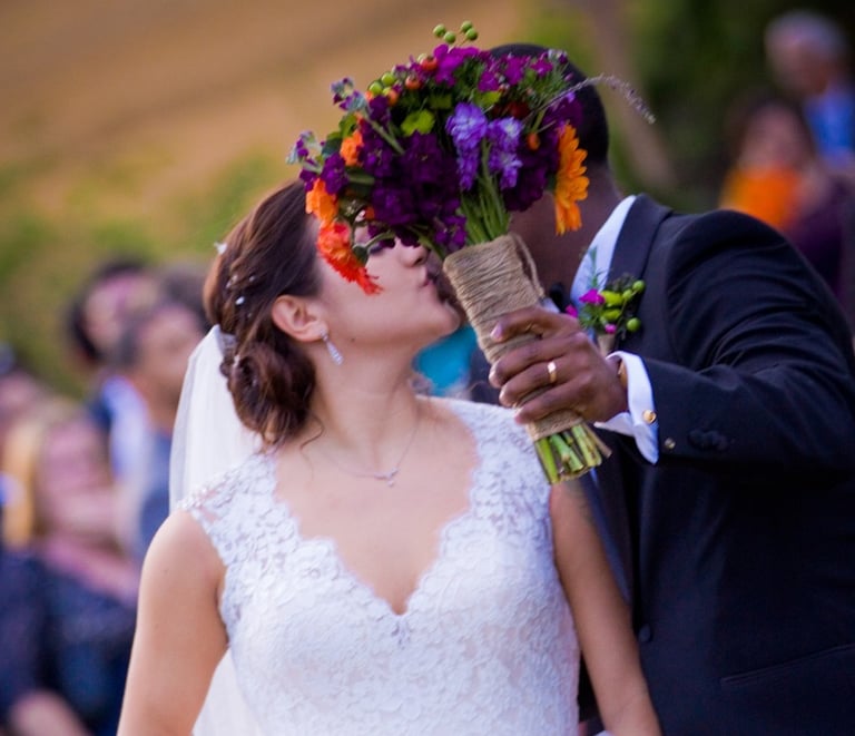 Bride and Groom kissing. Bouquet covering faces. Countryside Wedding The Comus Inn in Dickerson, MD