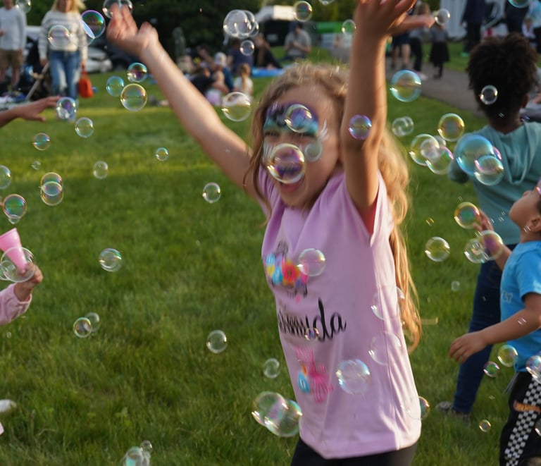 Young girl plays in bubbles