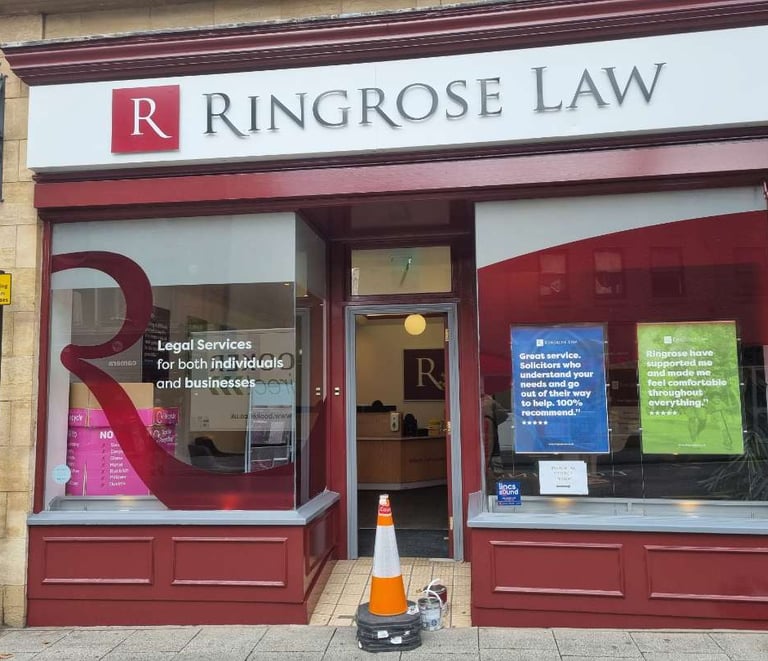 Front of Ringrose Law firm, with large branded windows and freshly red-painted detailing.
