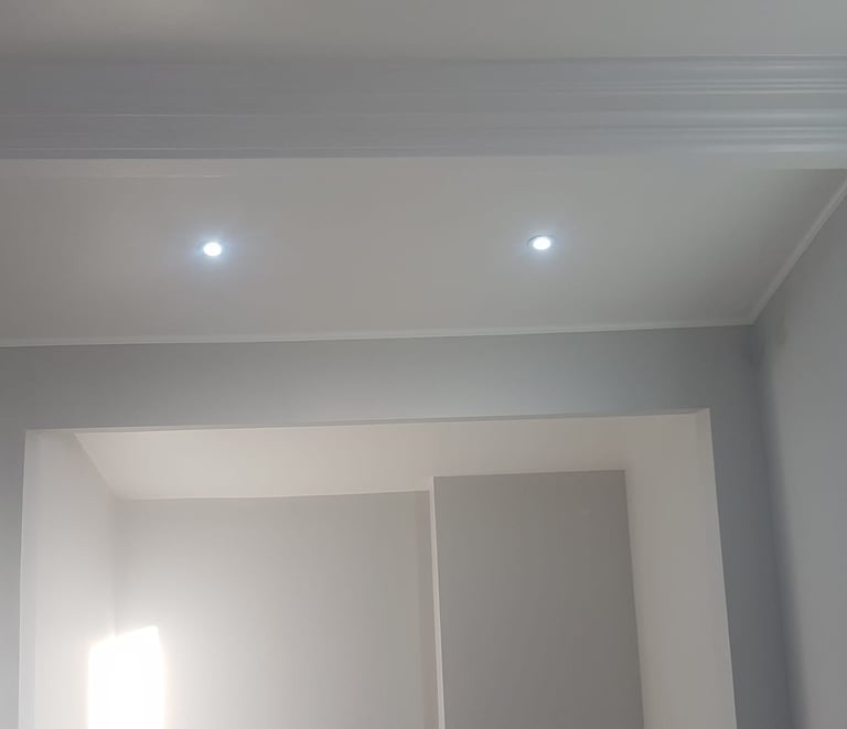 A well-lit, pale-white room with a concave space in the wall.