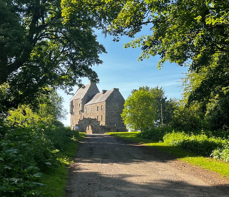 Path leading uphill with midhope castle (lallybroch) at the top