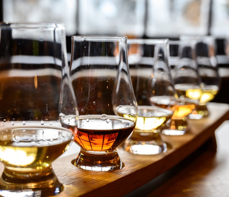 a row of glasses with different types of whisky