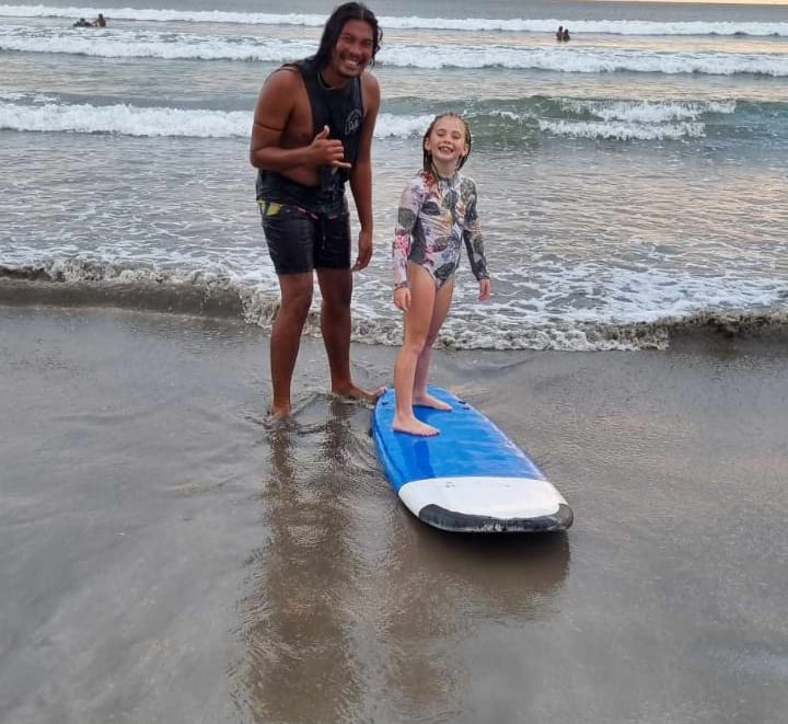 a woman and her daughter standing in the water