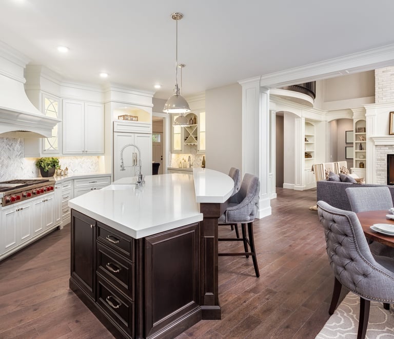 Newly built kitchen featuring custom cabinetry, countertops, flooring, and lighting