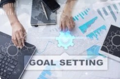 Business professional analyzing financial growth charts and digital goal setting icons for strategy planning.