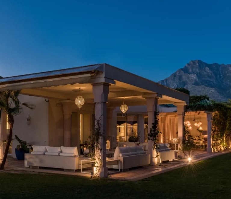 Illuminated pavilion at Villa El Rincon against the mountains