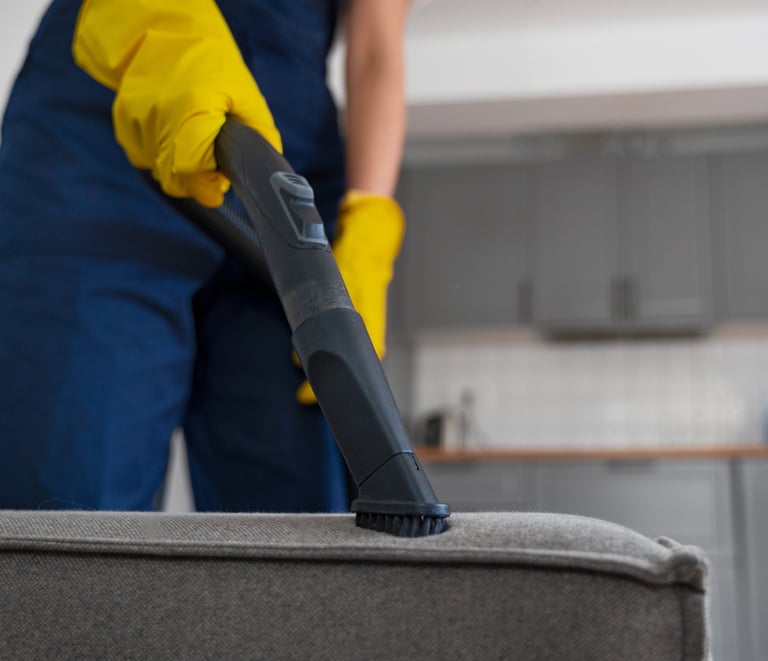 KLEAN WELL professional deep cleaning a couch to remove dust, allergens, and hidden dirt