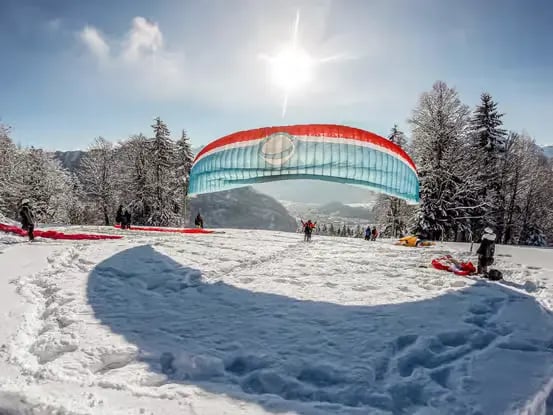 Paragliding wing laid out on snow at Amisbühl launch site ready for winter takeoff