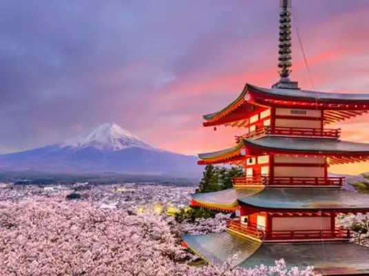 Iconic Chureito Pagoda with Mt. Fuji in the background during a vibrant purple sunset.