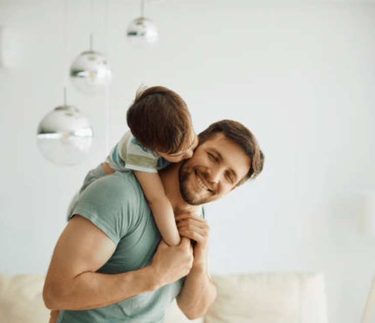 a man holding a child in his arms martin pe coach de pareja