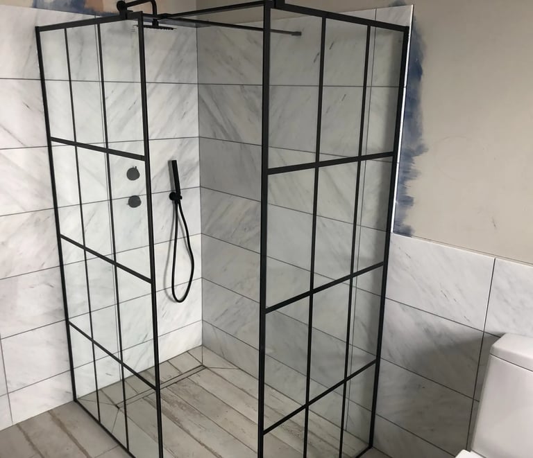 Modern walk-in shower installation with glass enclosure during bathroom renovation in Brighton.