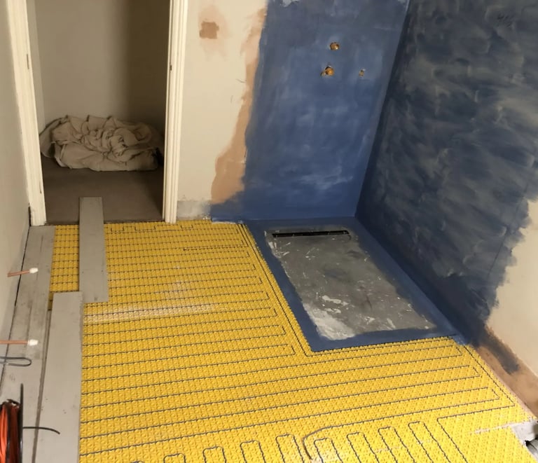 Bathroom renovation in progress with underfloor heating installation in Sussex home.