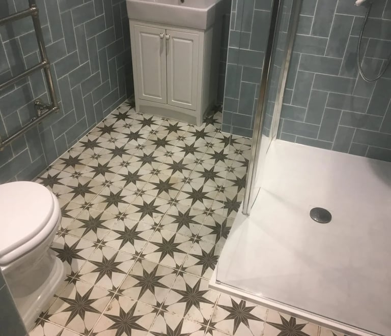 Bathroom renovation with patterned floor tiles and walk-in shower in Brighton property.