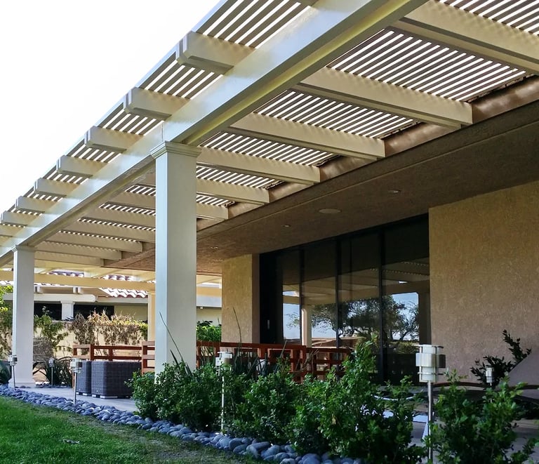 Large pergola over patio area and big sliding glass door.