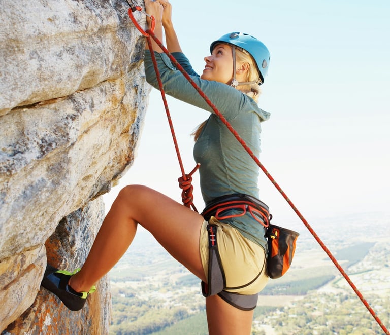 a woman climbing a rock 