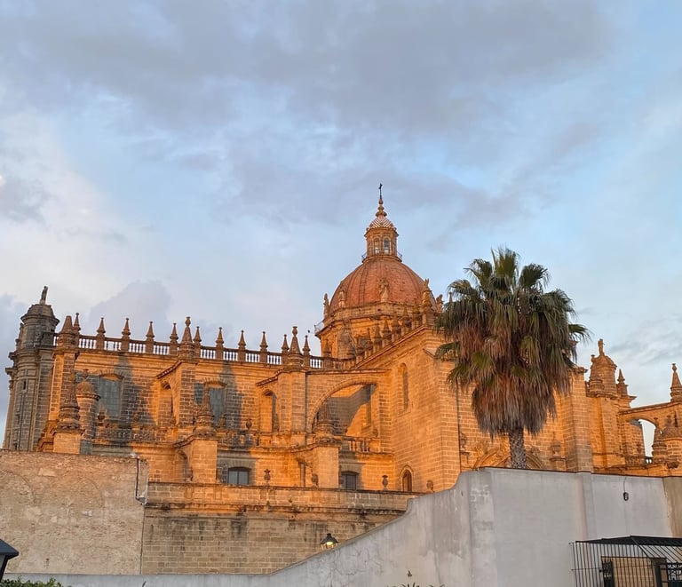 Sunset glow on the historic Jerez de la Frontera Cathedral dome and stone architecture in Spain.
