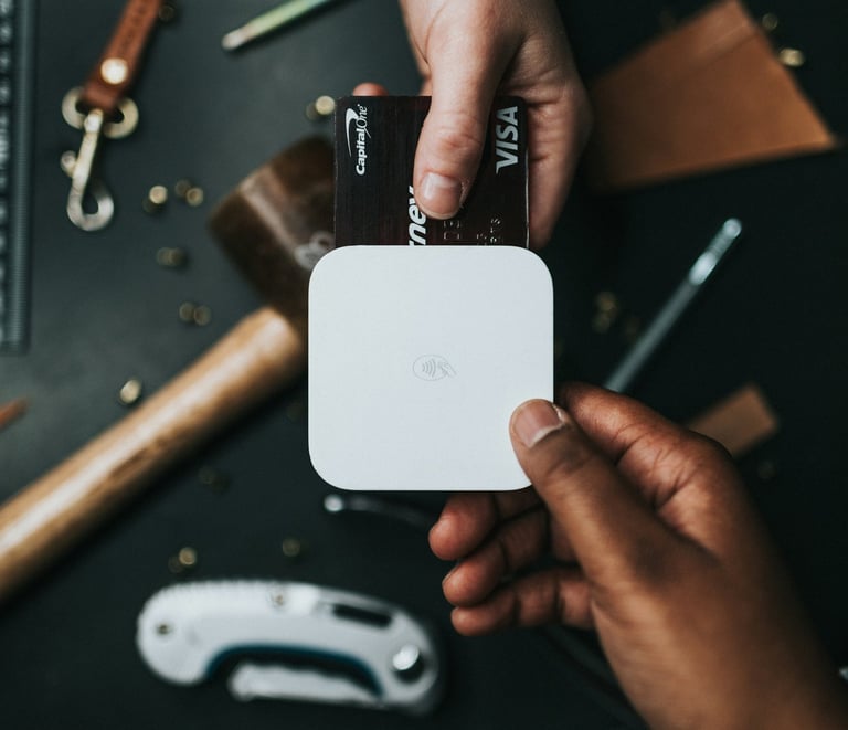 a person holding a small square shaped object