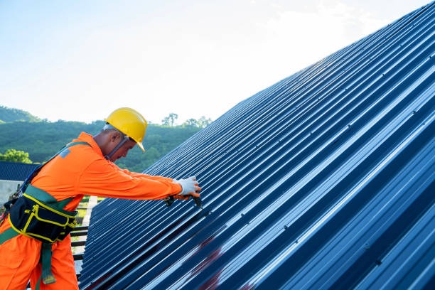 worker wearing protective equipment installing a metal roof
