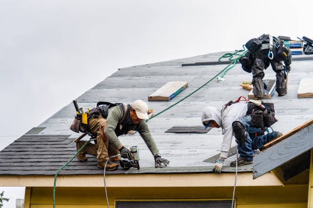 workers installing new roof tiles