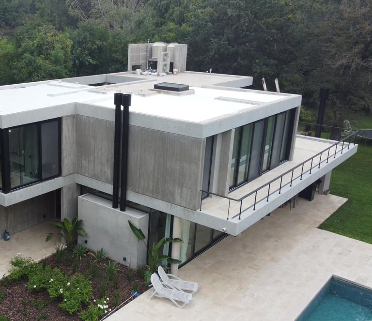 a house with a large roof and a pool