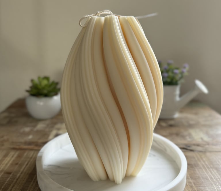 White twisted candle over a plate
