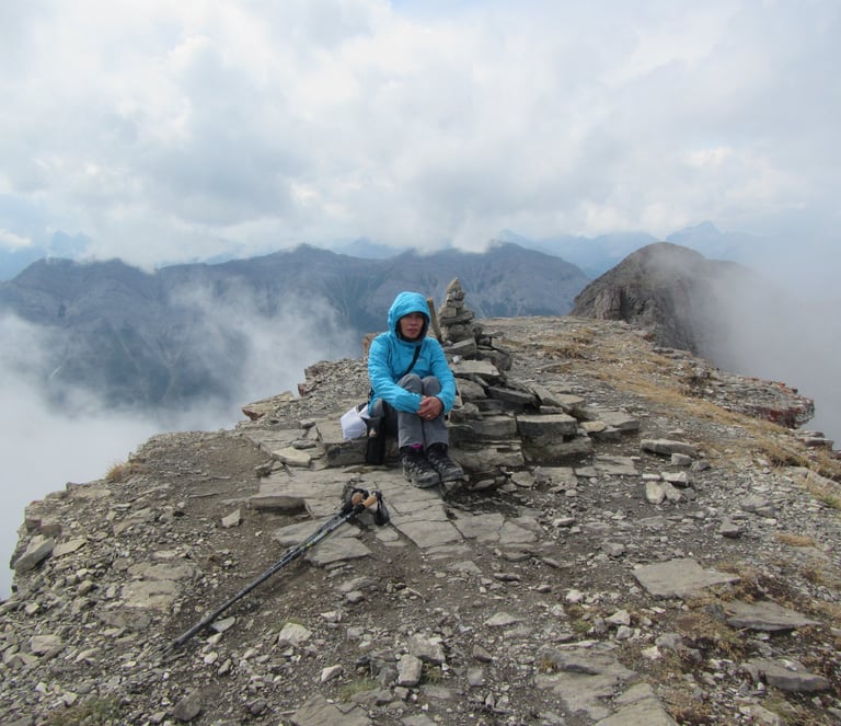 a person sitting on a mountain top