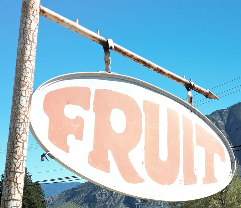 Old rusty Fruit sign identifying a road side fruit stand. The Similkameen Valley of British Columbia.