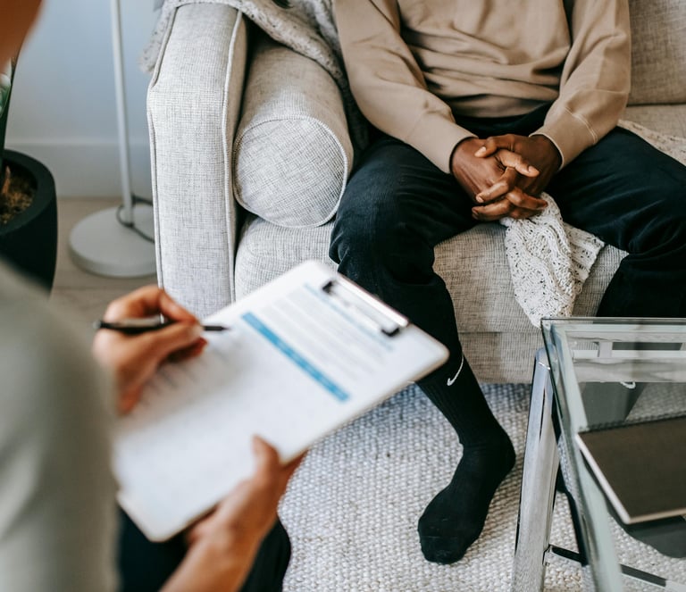 man sits on sofa in a consultation