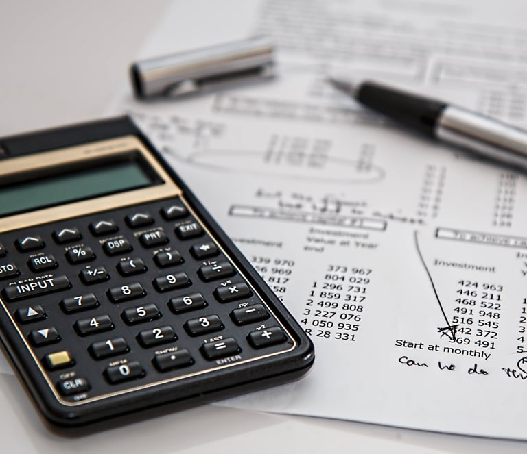 a calculator and pen on a paper with a pen