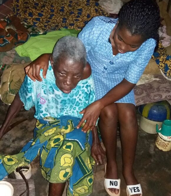 Missionary sister caring for an elderly woman with compassion and support