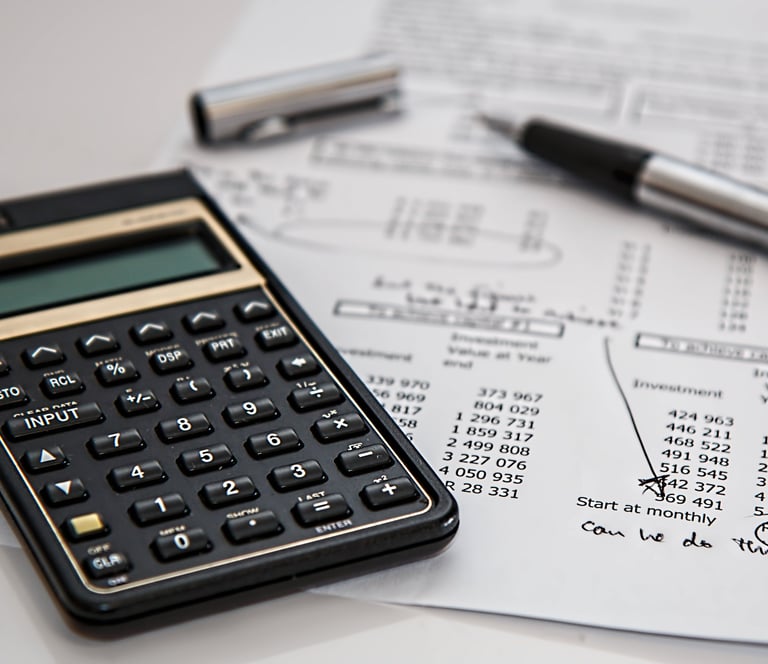 a calculator and pen on a paper with a pen