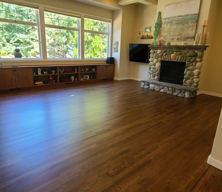 a beautiful deep brown hardwood floor with stone fireplace