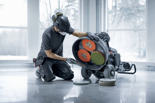 Changing grinding pads to reduce abrasion to hone floors for a smoother surface.