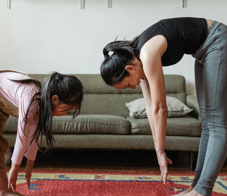 a woman and a child are standing on a rug doing stretching exercises