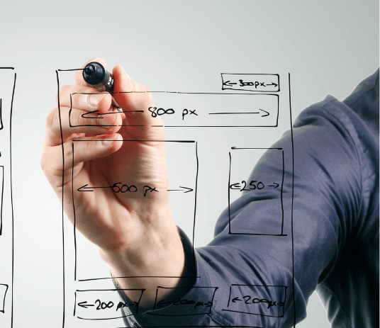 a man writing a website page plan on a whiteboard