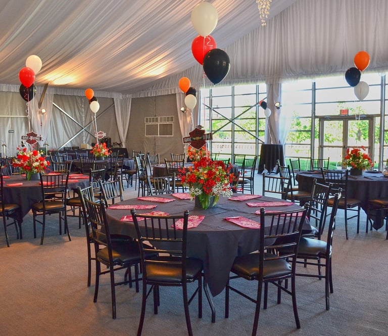 a large room with tables and chairs and balloons and flower decoration
