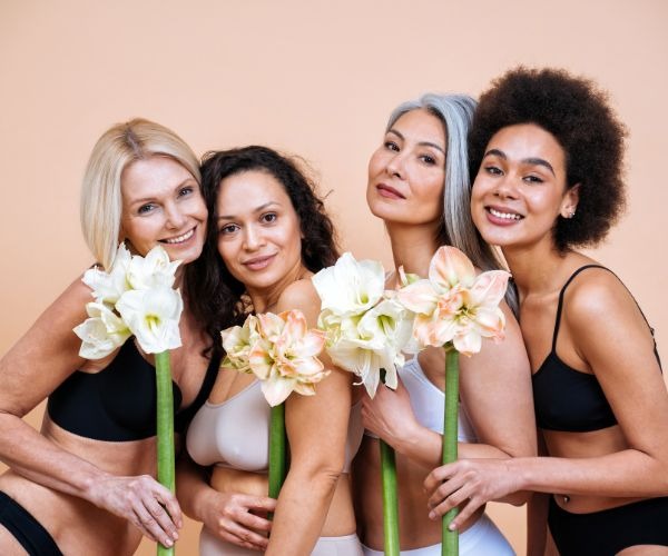 a group of women in bikinis posing for a photo