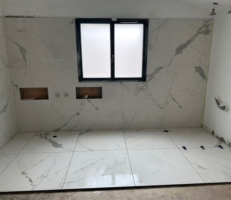 Résultat final après rénovation complète avec pose de carrelage marbre blanc grand format. Harenova
