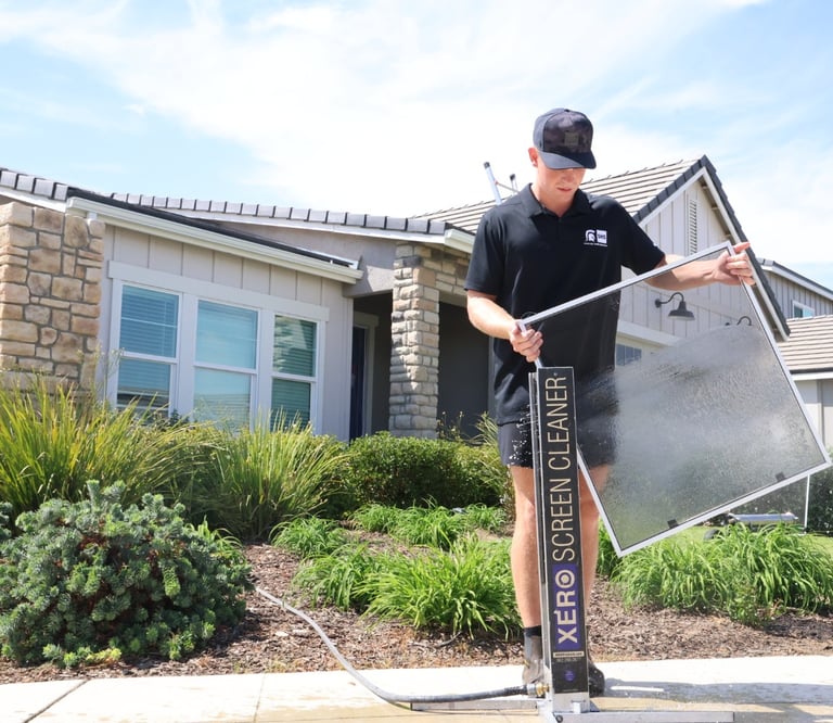 luke washing a screen using the screen cleaning machine