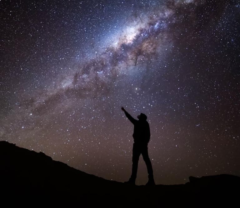 a person pointing at the stars in the sky