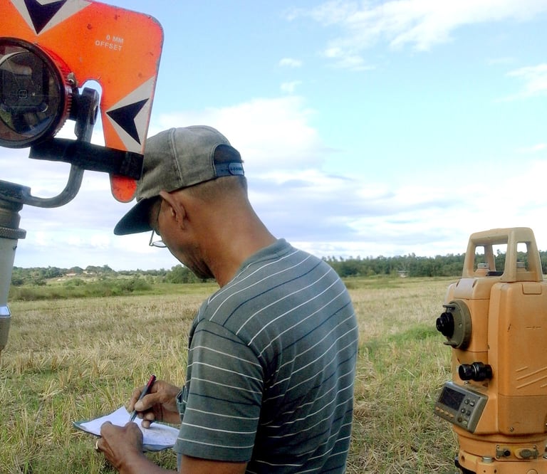 Licensed Surveyor Engineer conducting land survey or land surveying, construction survey