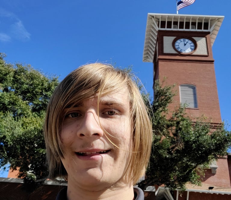 The Owner of the lutz clock company in frount of a clock tower