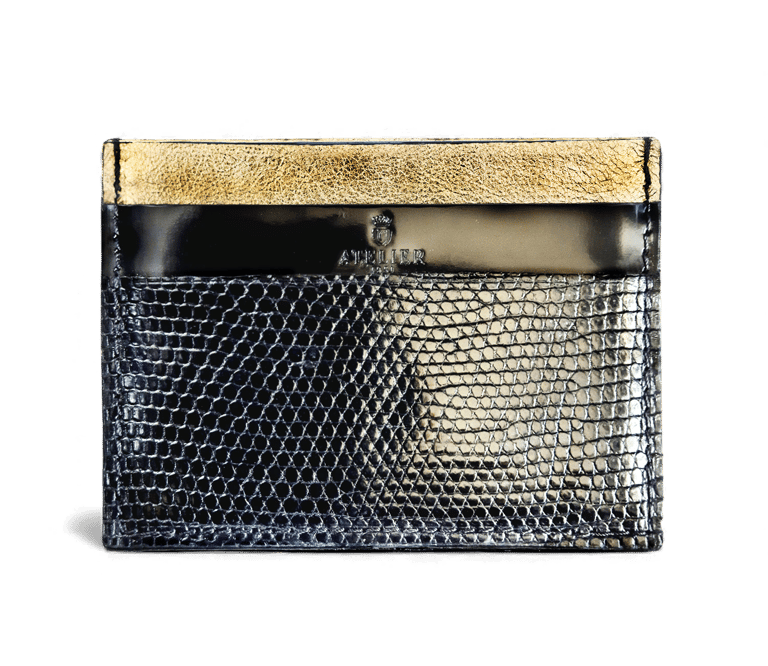 Luxury black snakeskin card holder with gold trim and embossed Atelier logo on a black background.