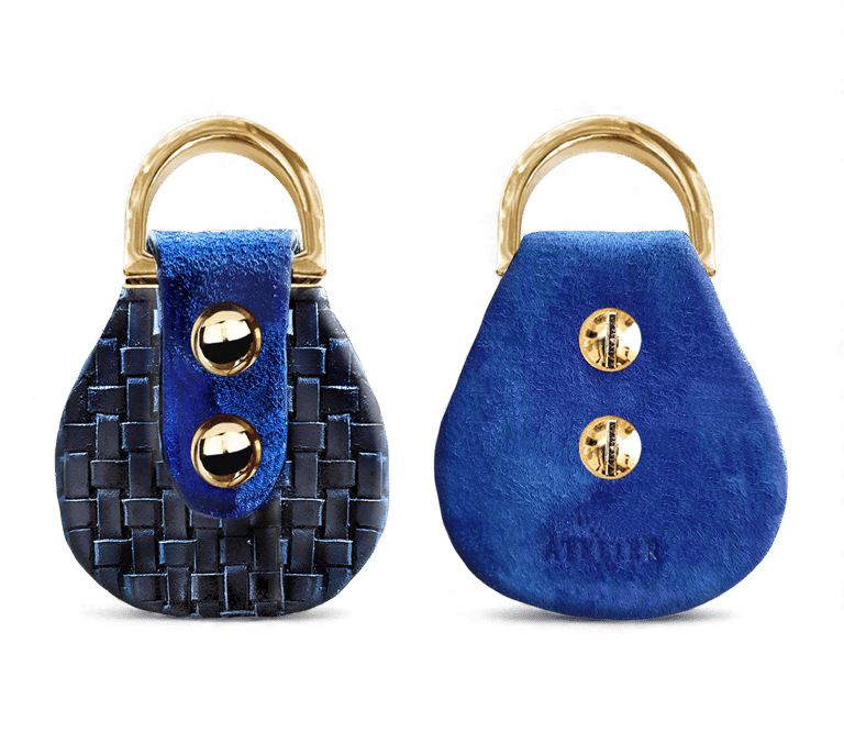 Handmade blue leather key fob with woven textures and gold metal hardware for luxury accessories.