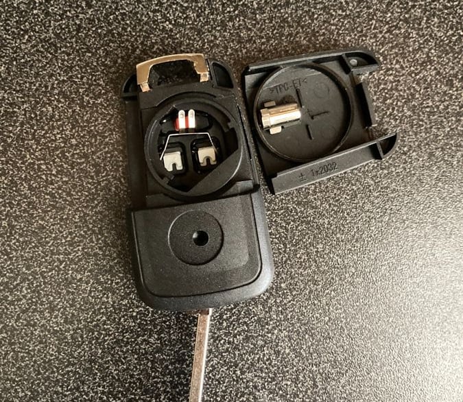 #Aftermarket Chevy flip key remote opened – showing battery compartment and buttons