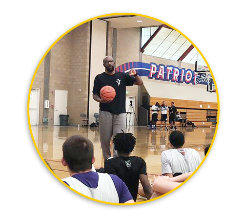 Pic of Coach Joell Crawford in front of basketball athletes